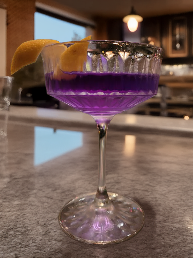 A Purple Gin Martini infused with butterfly pea tea in a living room setting
