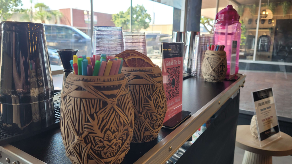 fresno mobile bar setup with shakers, tiki mugs, and citrus garnishes at a gym launch party showcasing the versitility in mobile bar events in fresno california